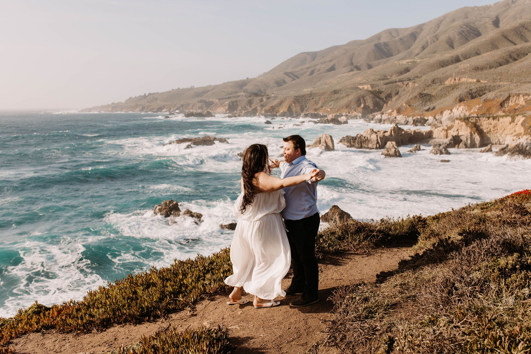 Couple posing on a cliff in california